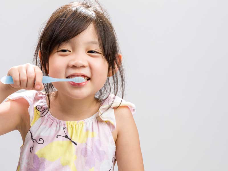 Little Girl is Brushing Her Teeth